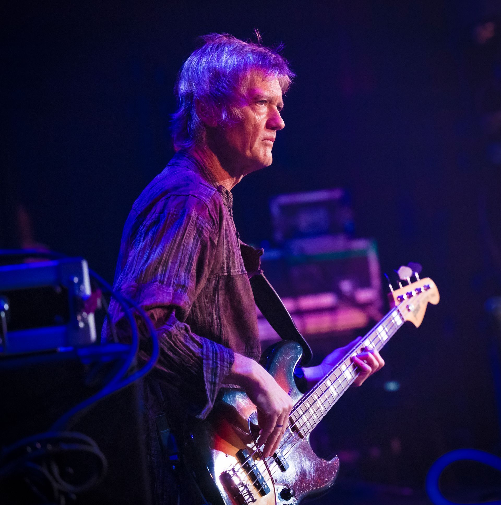 A man is playing an electric guitar on a stage