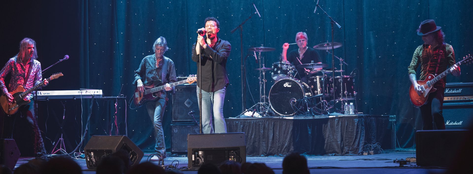 A group of people are playing instruments on a stage.