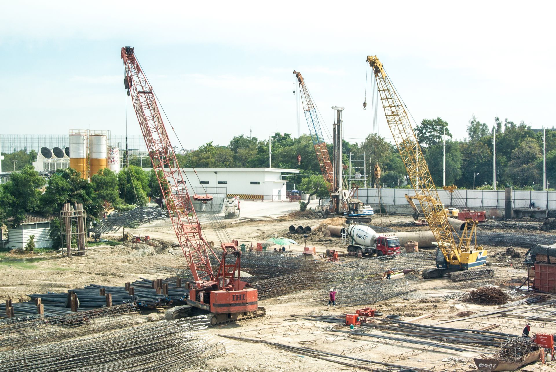 A construction site with a lot of cranes and machinery