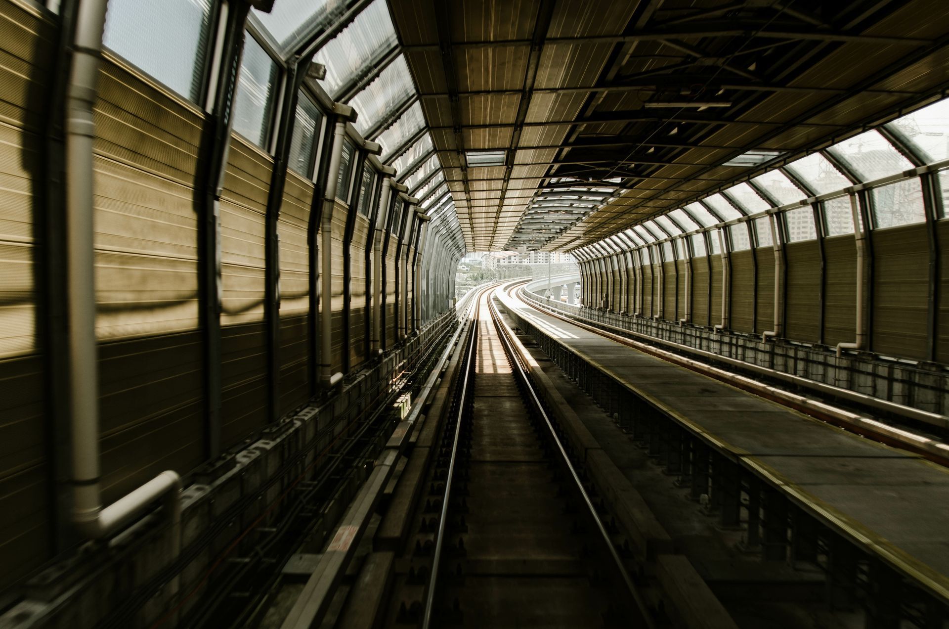 A train is going down the tracks in a tunnel.