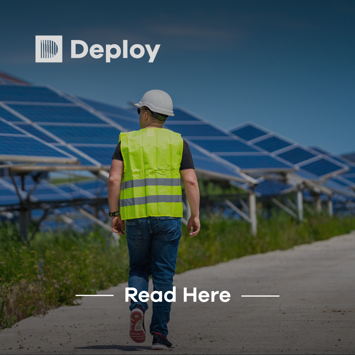 Worker in safety vest and hard hat walks near solar panels, Deploy logo present, read here prompt.