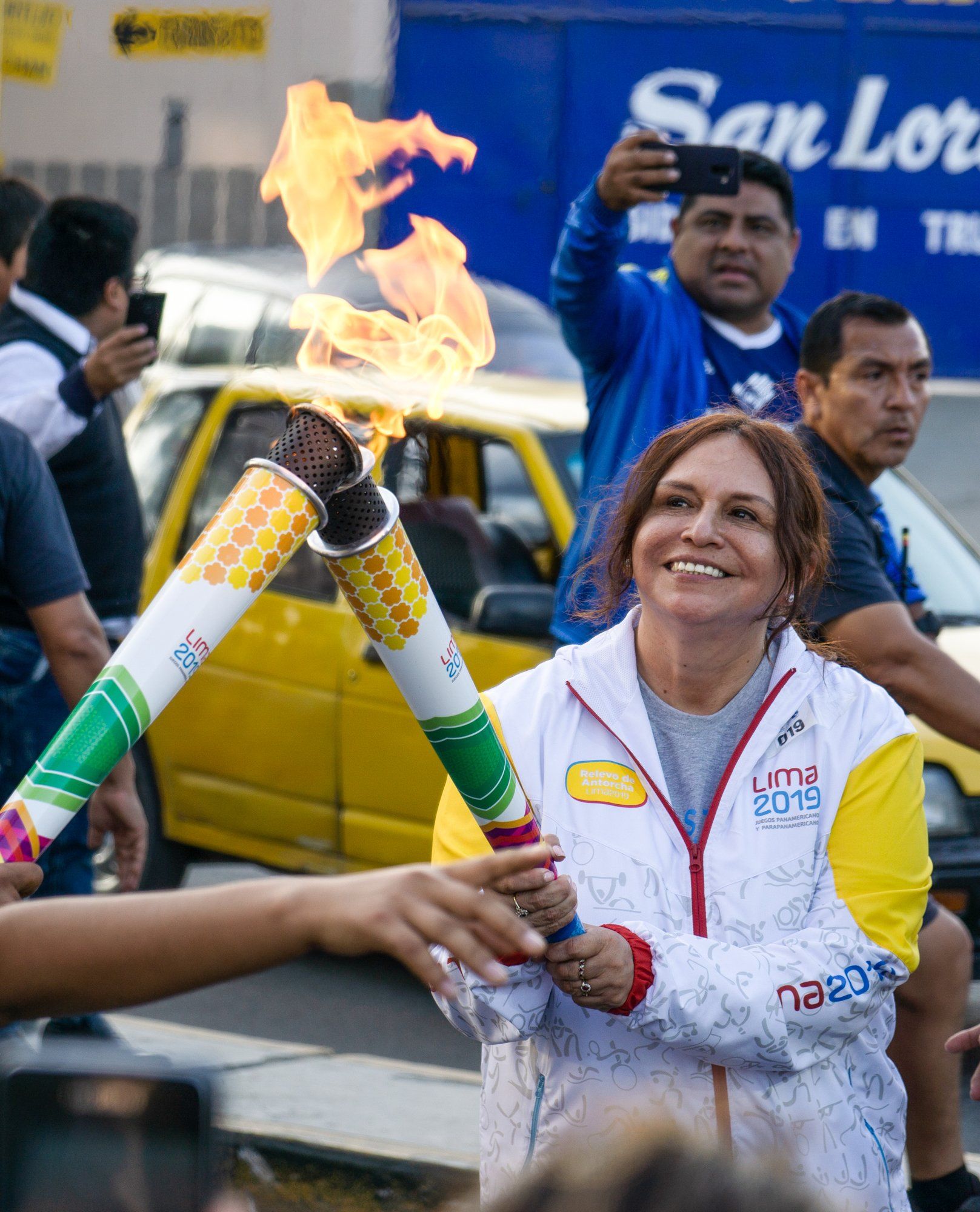 Otra Cosa's director carrying the Olympic flame.