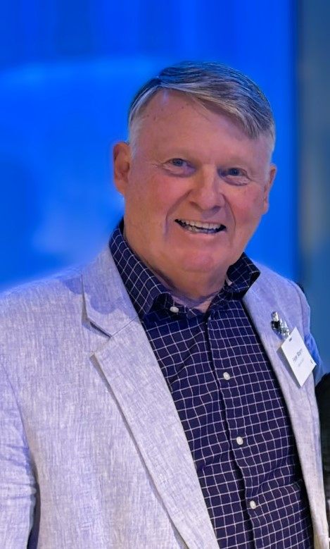 Four people in formal attire smiling and posing for a photo.