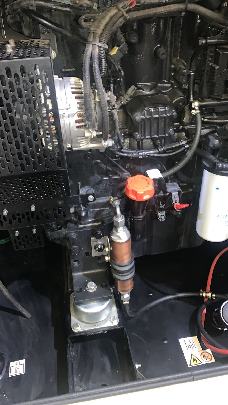 Black diesel engine with components like a fuel filter, alternator, and radiator.