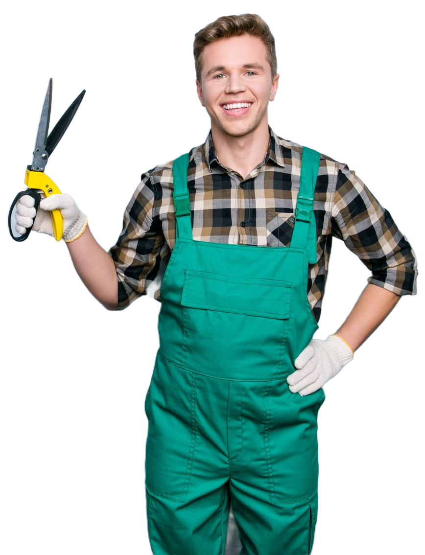 A smiling person in green coveralls and a plaid shirt holds yellow-handled garden shears while wearing gloves.
