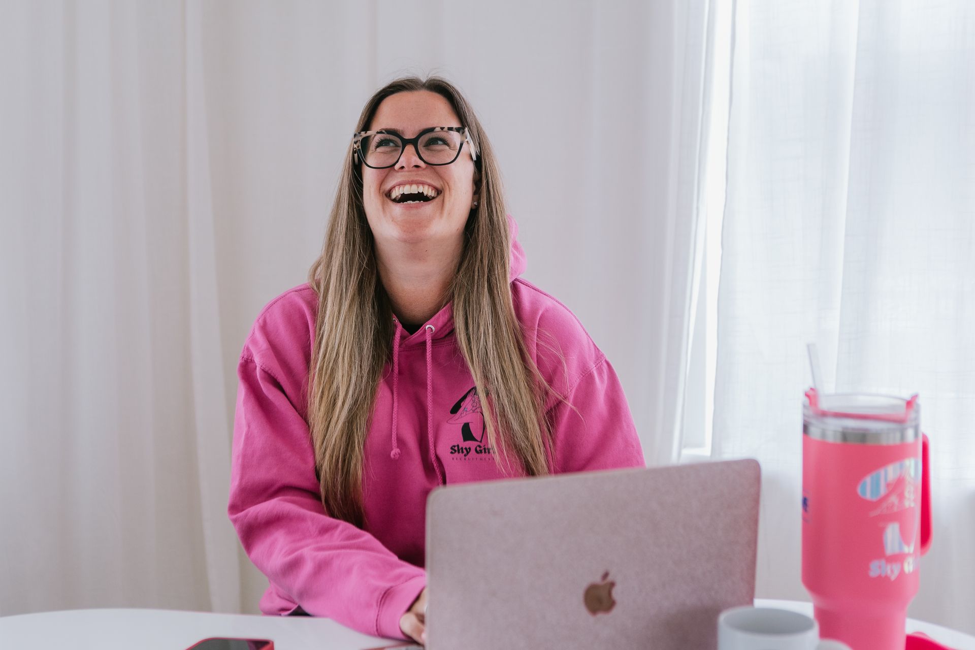 Woman learning webcam tips from online course with notebook and laptop