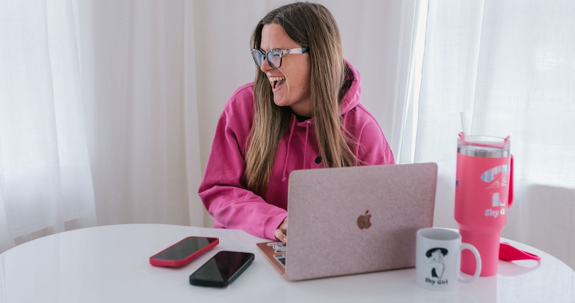 Woman learning webcam tips from online course with notebook and laptop