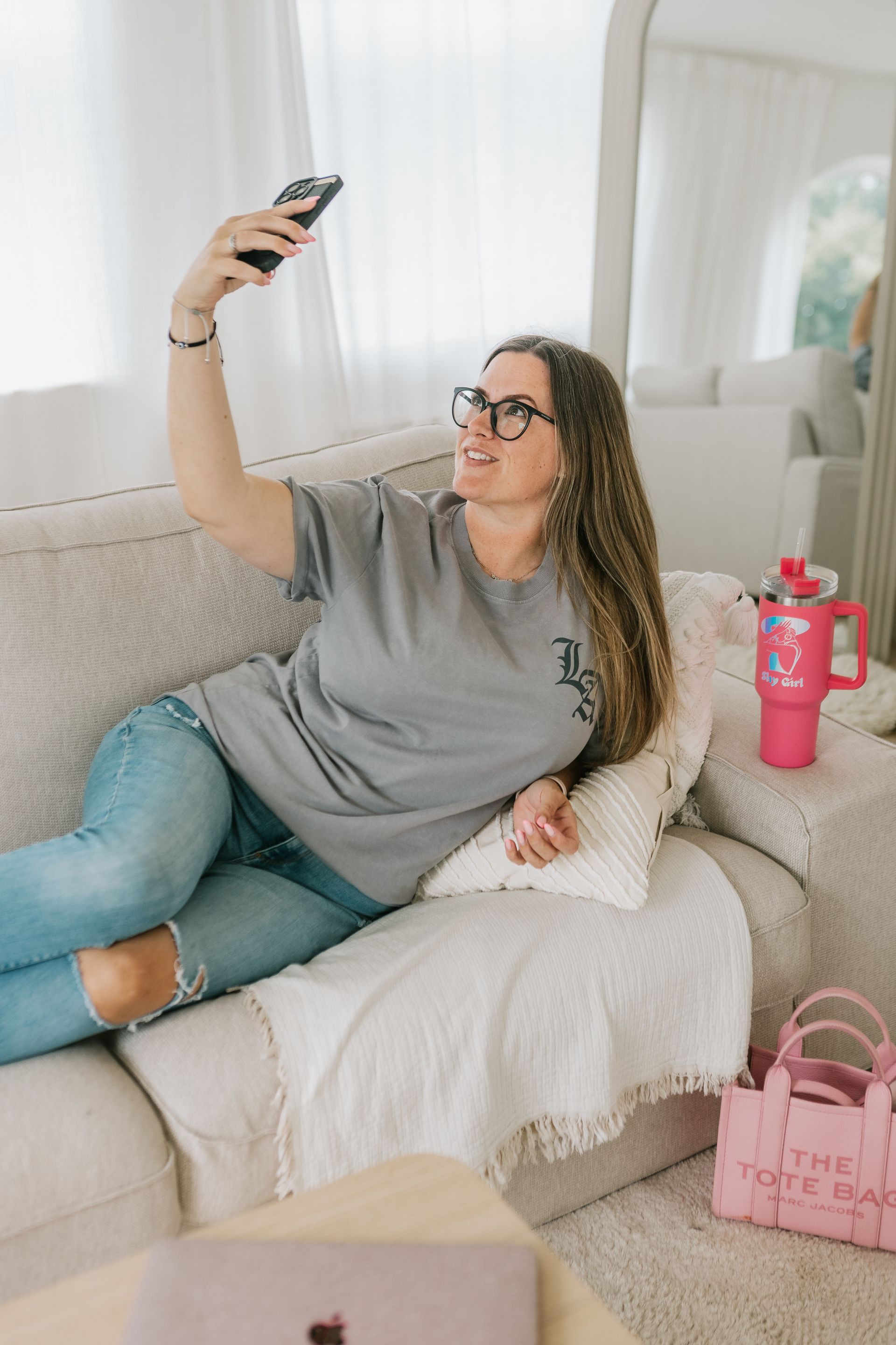 Woman learning webcam tips from online course with notebook and laptop