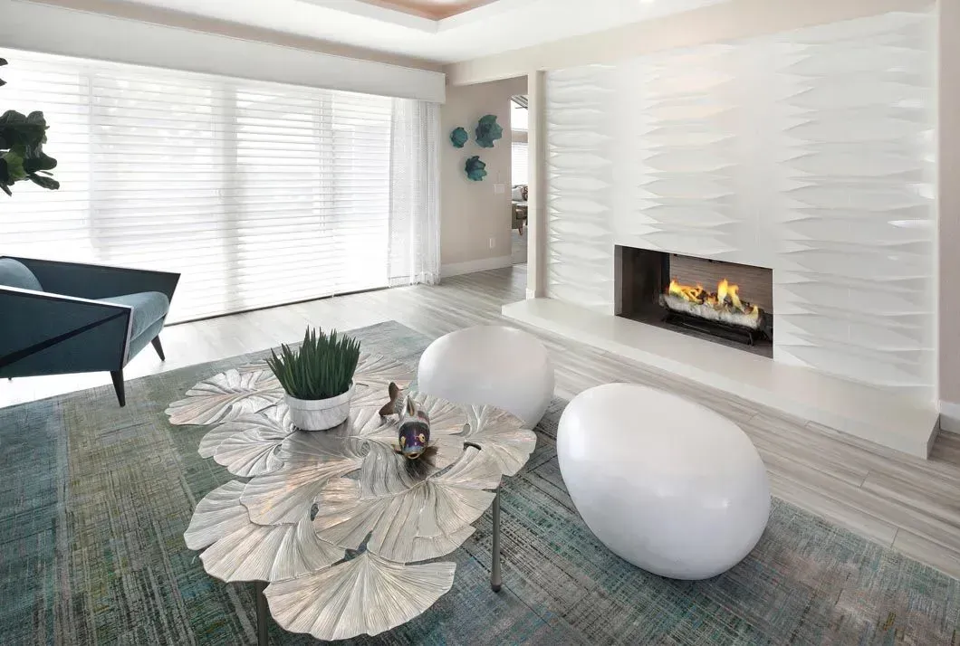 Living room with fireplace, modern furniture, and a blue and white color scheme.