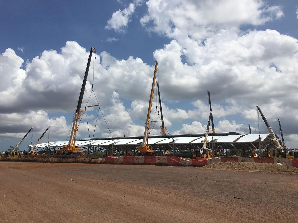 A large building is being built with a lot of cranes.