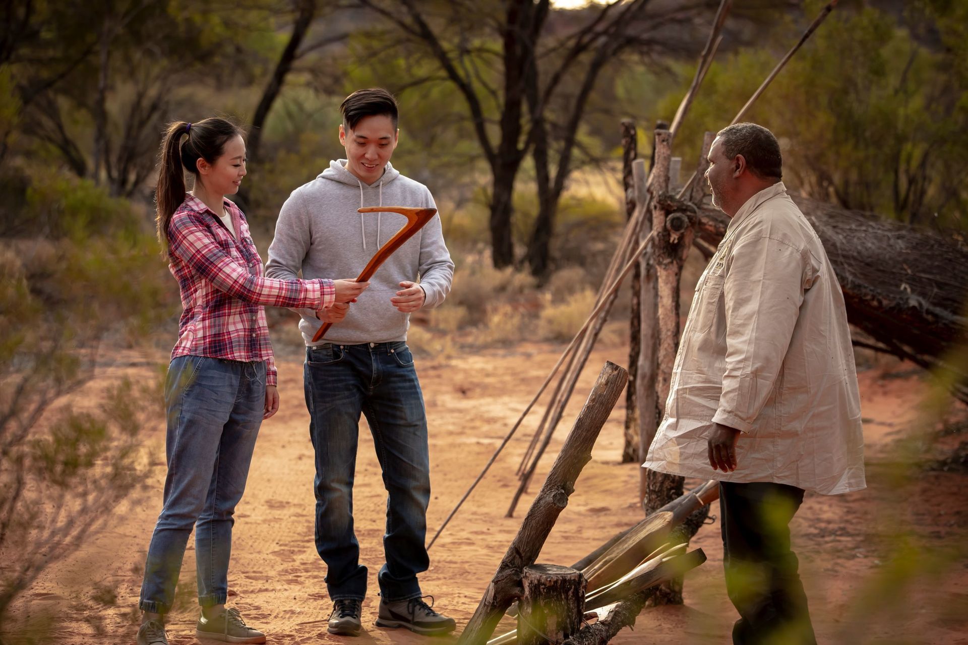 A man and a woman are standing next to each other in the desert.