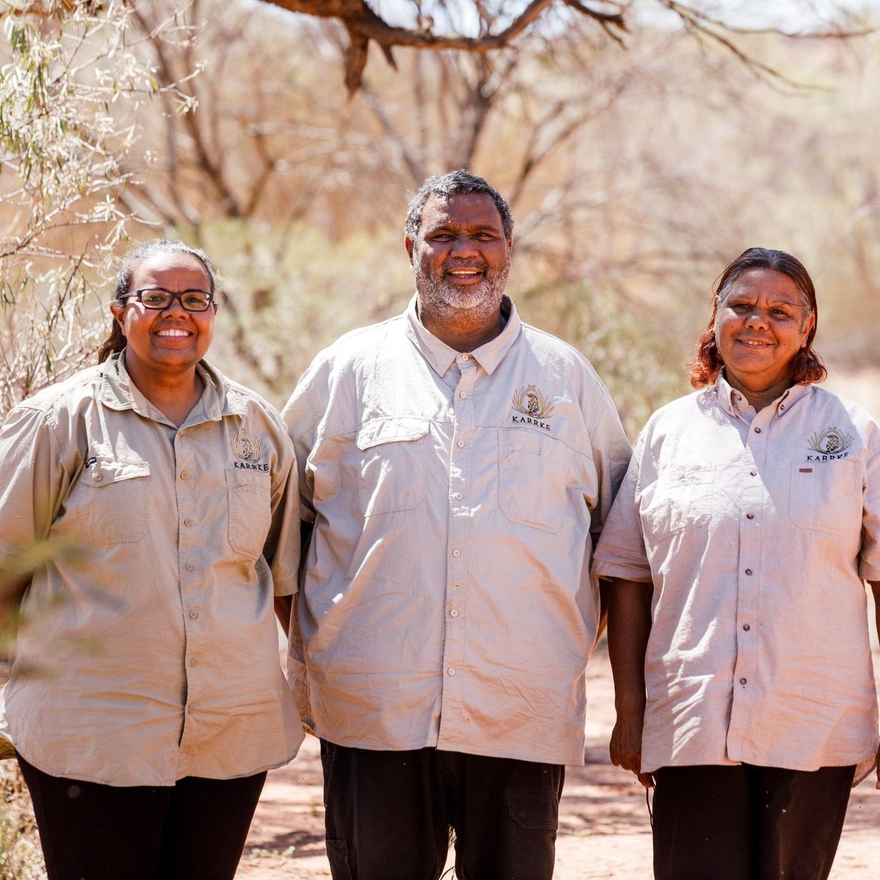 A man and two women are posing for a picture together