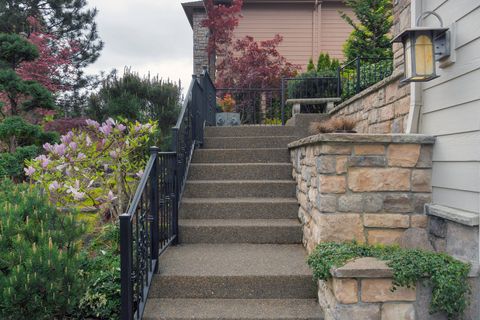 a concrete stairs and a stone brick retaining wall