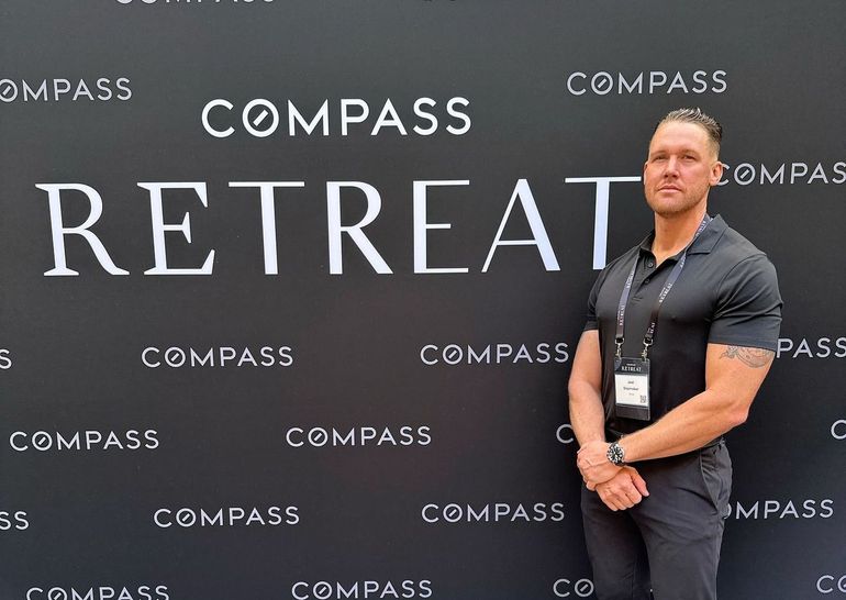 Joel Slaymaker standing in front of the Compass Retreat sign