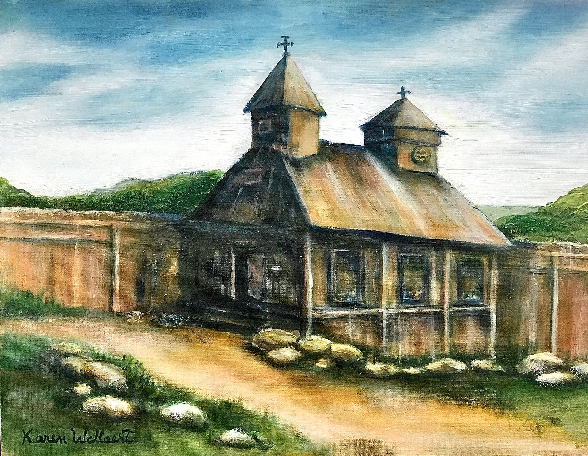 A wooden church with two towers, surrounded by a fence and a path, under a cloudy sky.