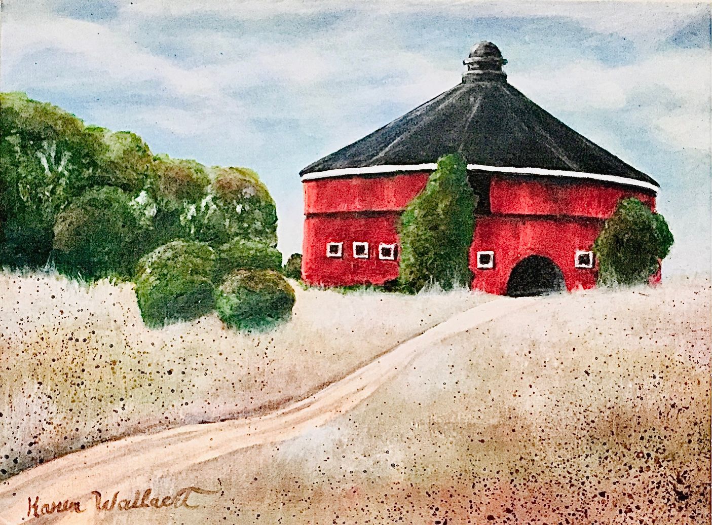 Red round barn with black roof, trees, and dirt road.