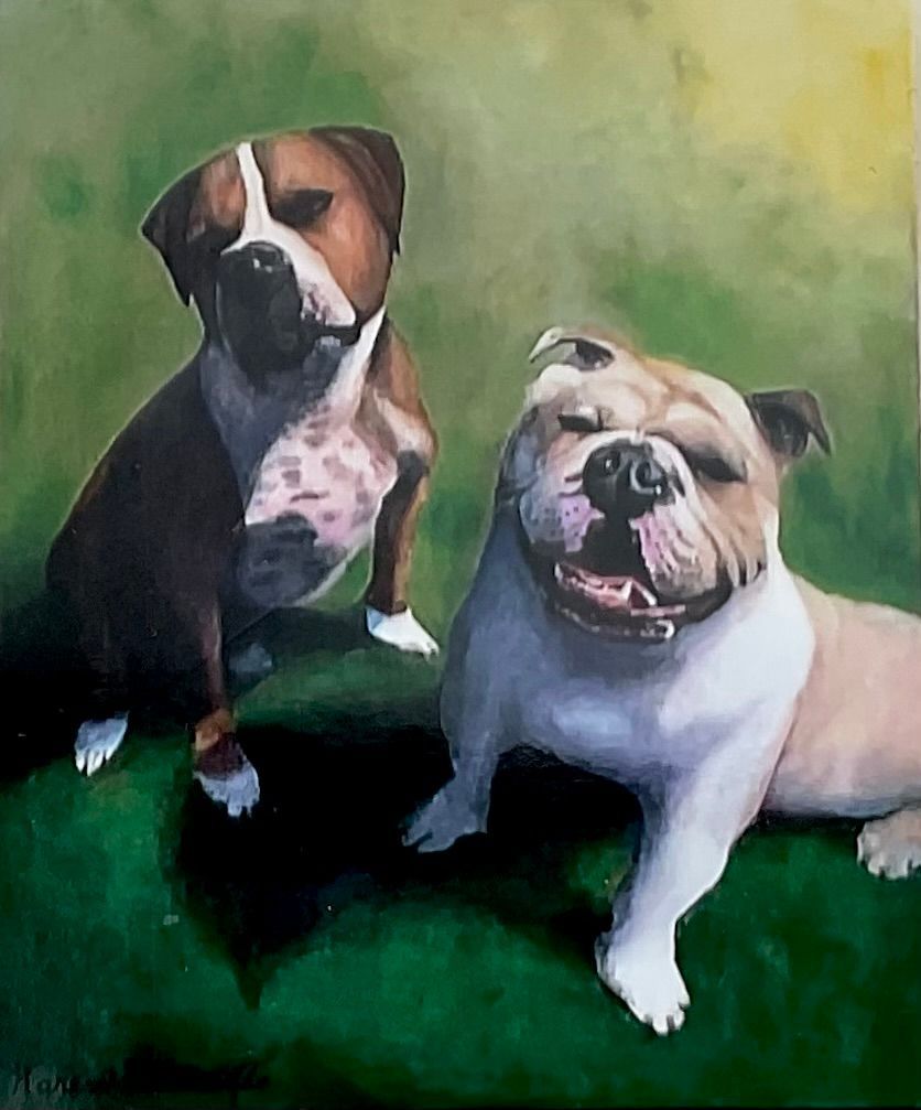 Two dogs, a brown and white pitbull, and a cream bulldog on green grass. The bulldog smiles, while the other stares.