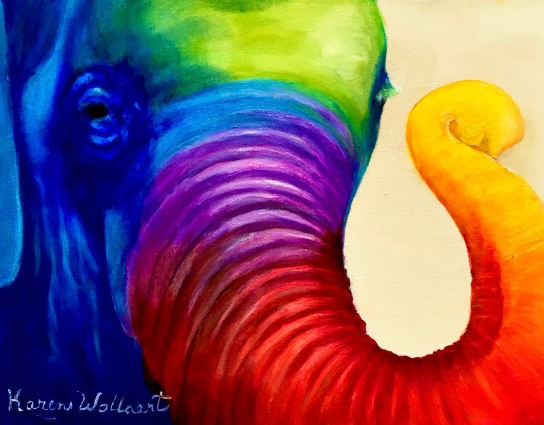 Rainbow-colored elephant head, trunk curled. Painted in vibrant hues.