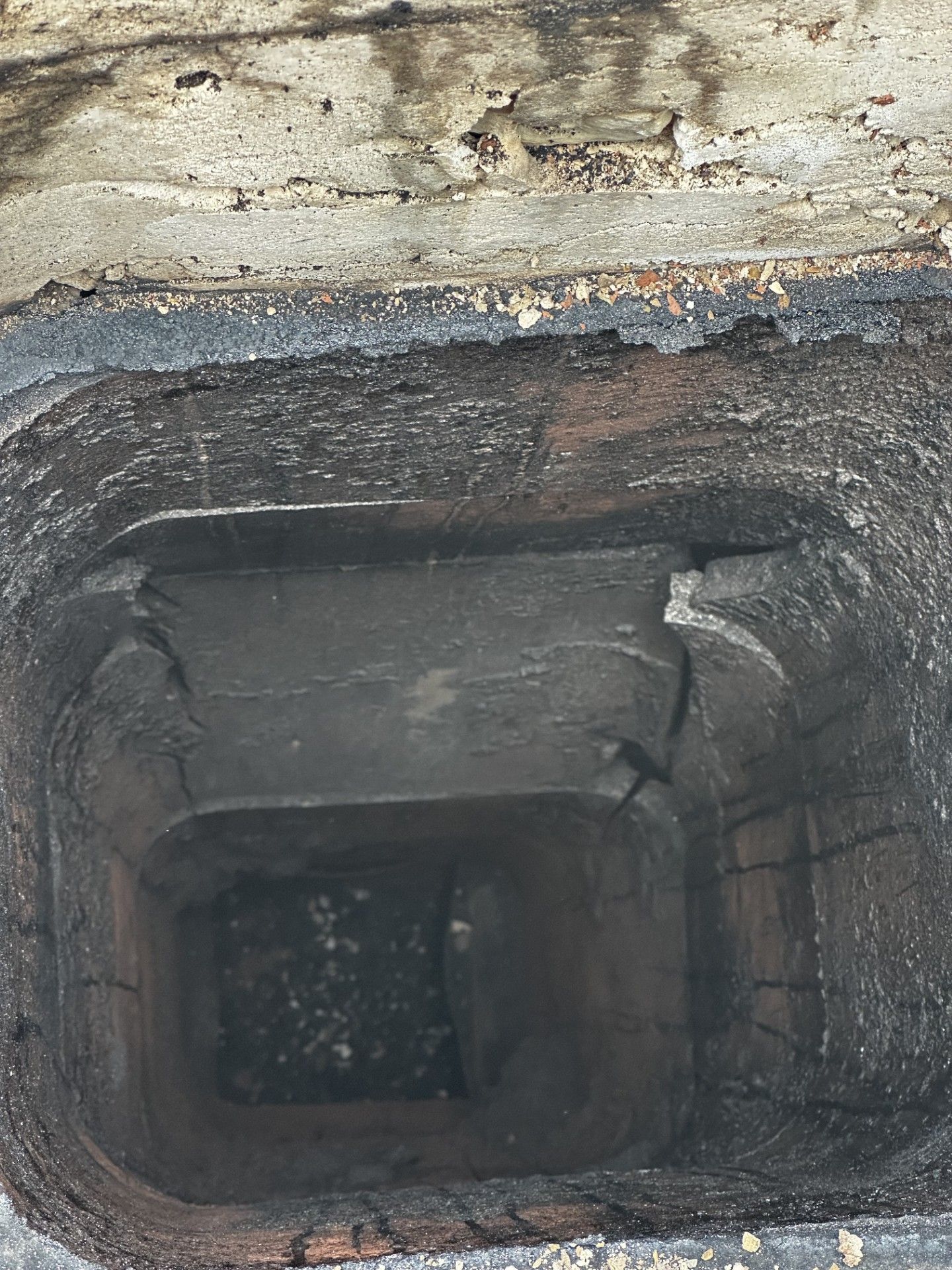 A close up of a hole in a wall with water coming out of it.