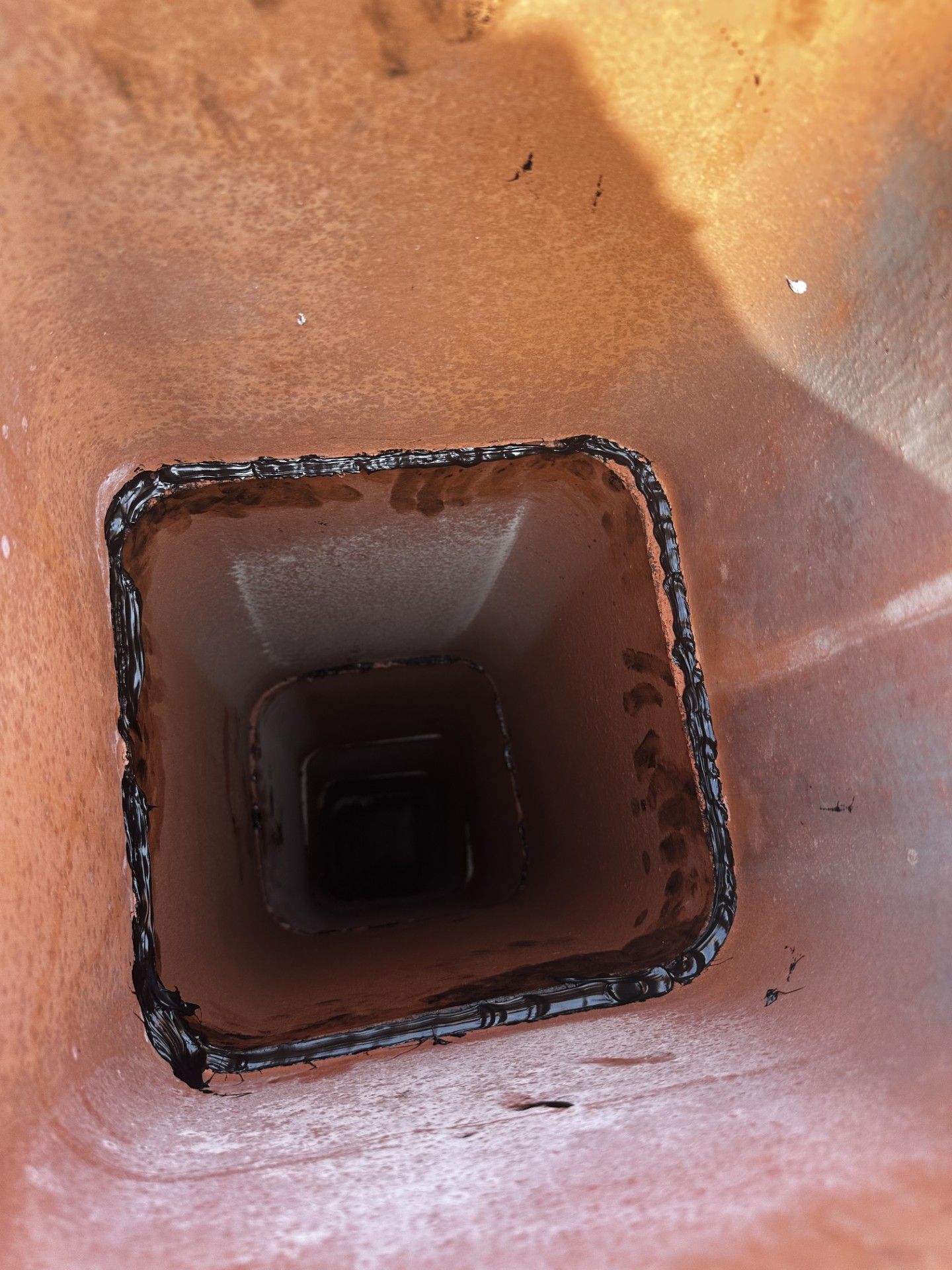 A close up of a square hole in a wall