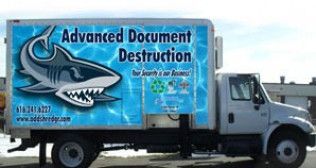 An advanced document destruction truck with a shark on the side