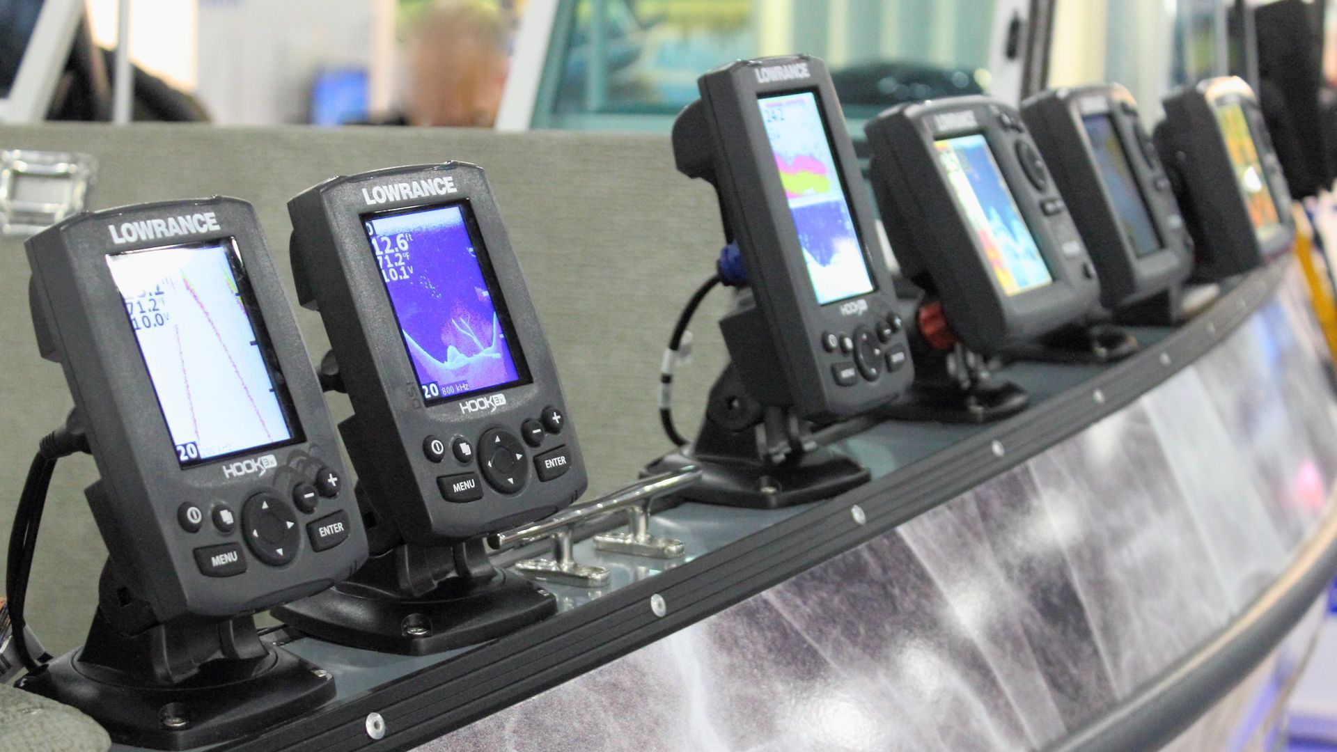 Row of handheld GPS units displayed on a tilted retail shelf
