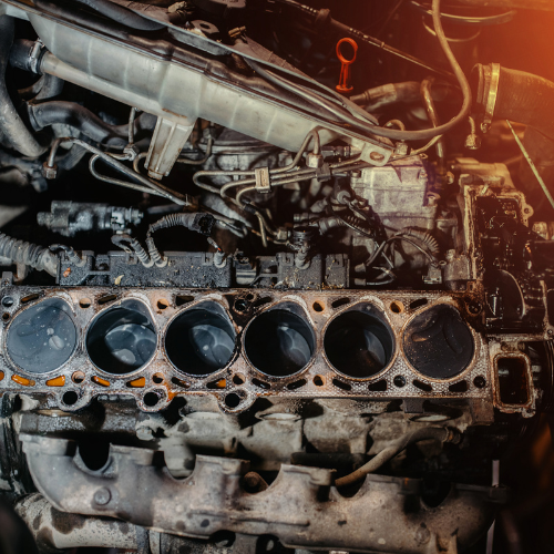 Close-up of a car engine block, showing cylinder heads and internal components.