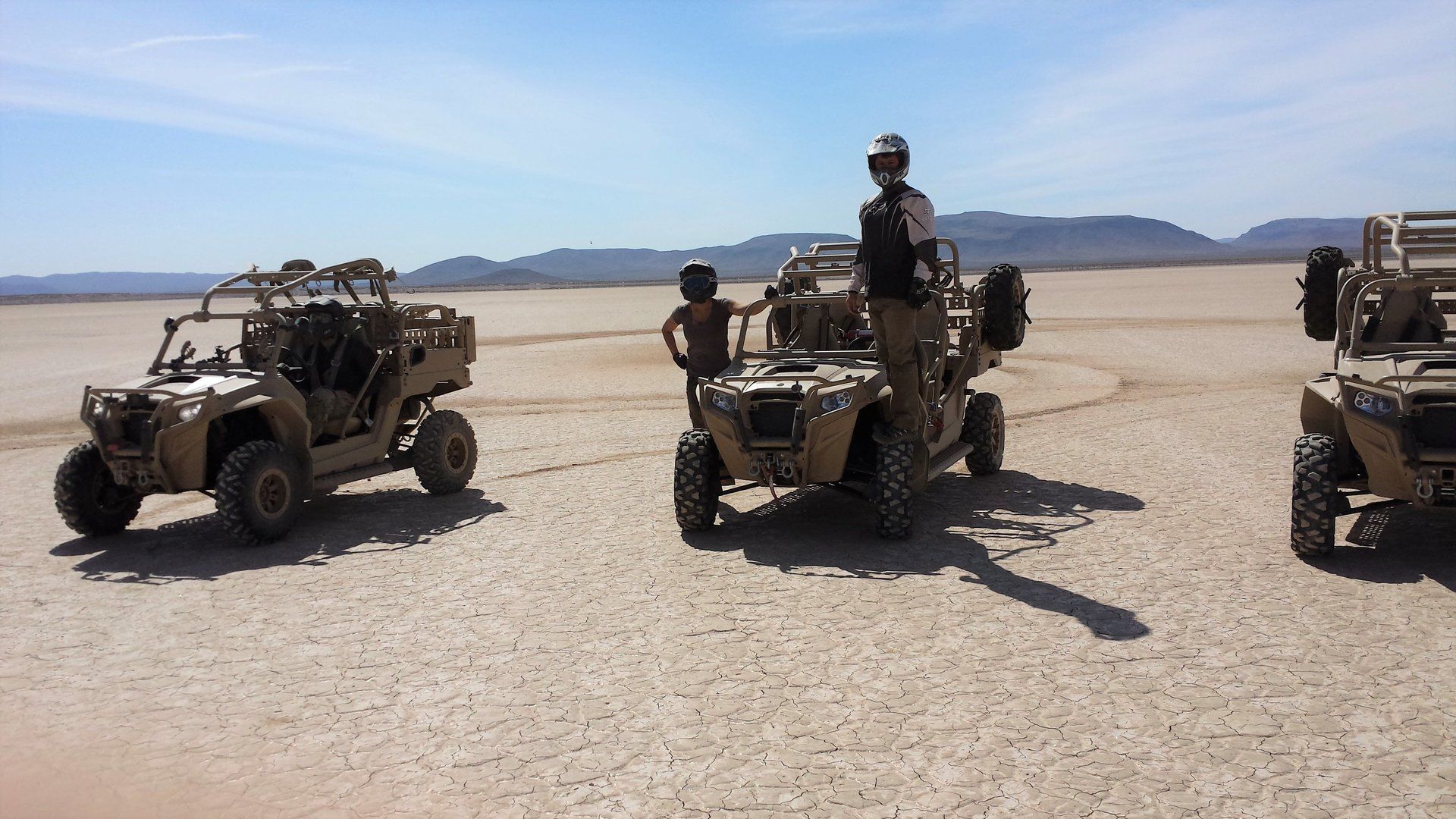 Roper CEO Maeve Garigan with Navy SEALs test driving all-terrain vehicles in the Mojave Desert.