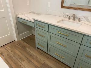 A kitchen with a stainless steel refrigerator and a wooden table.
