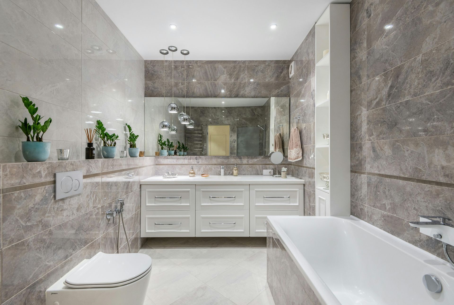 A bathroom with a tub , toilet , sink and mirror.