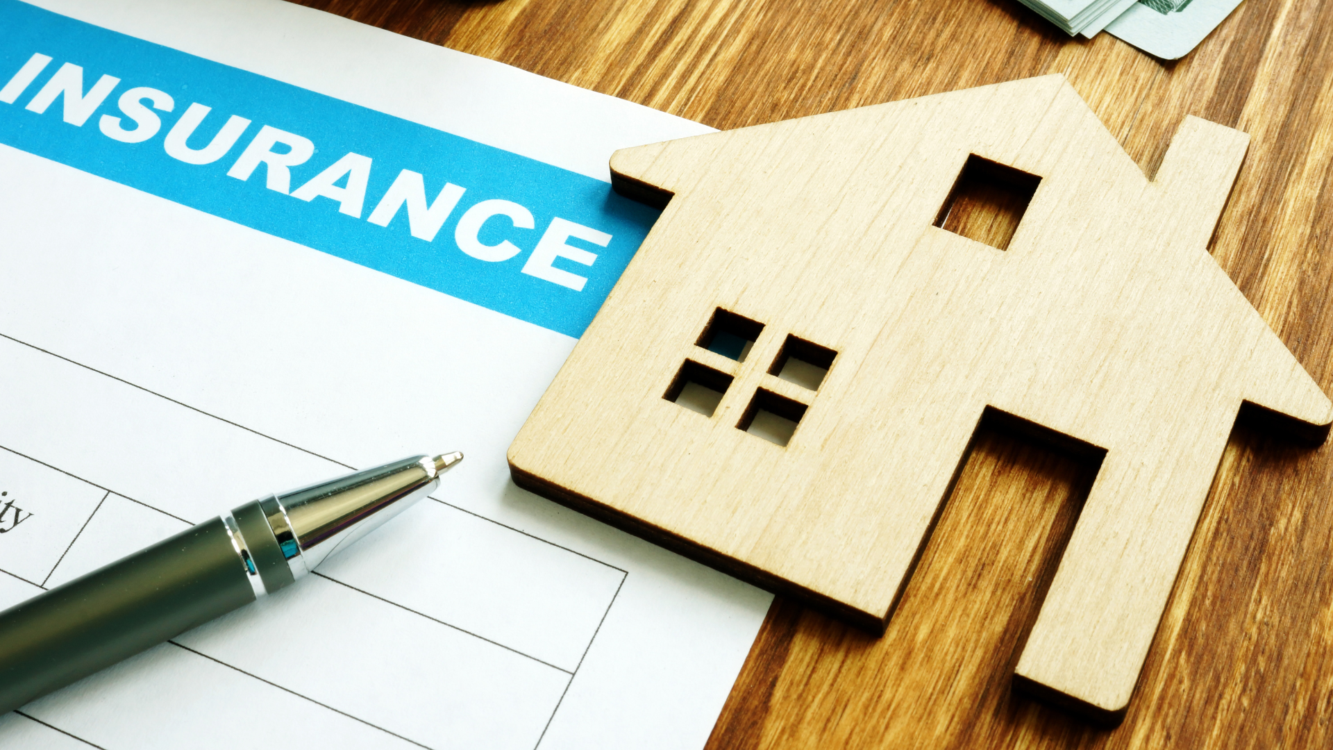 A pen is sitting on top of a piece of paper that says insurance.