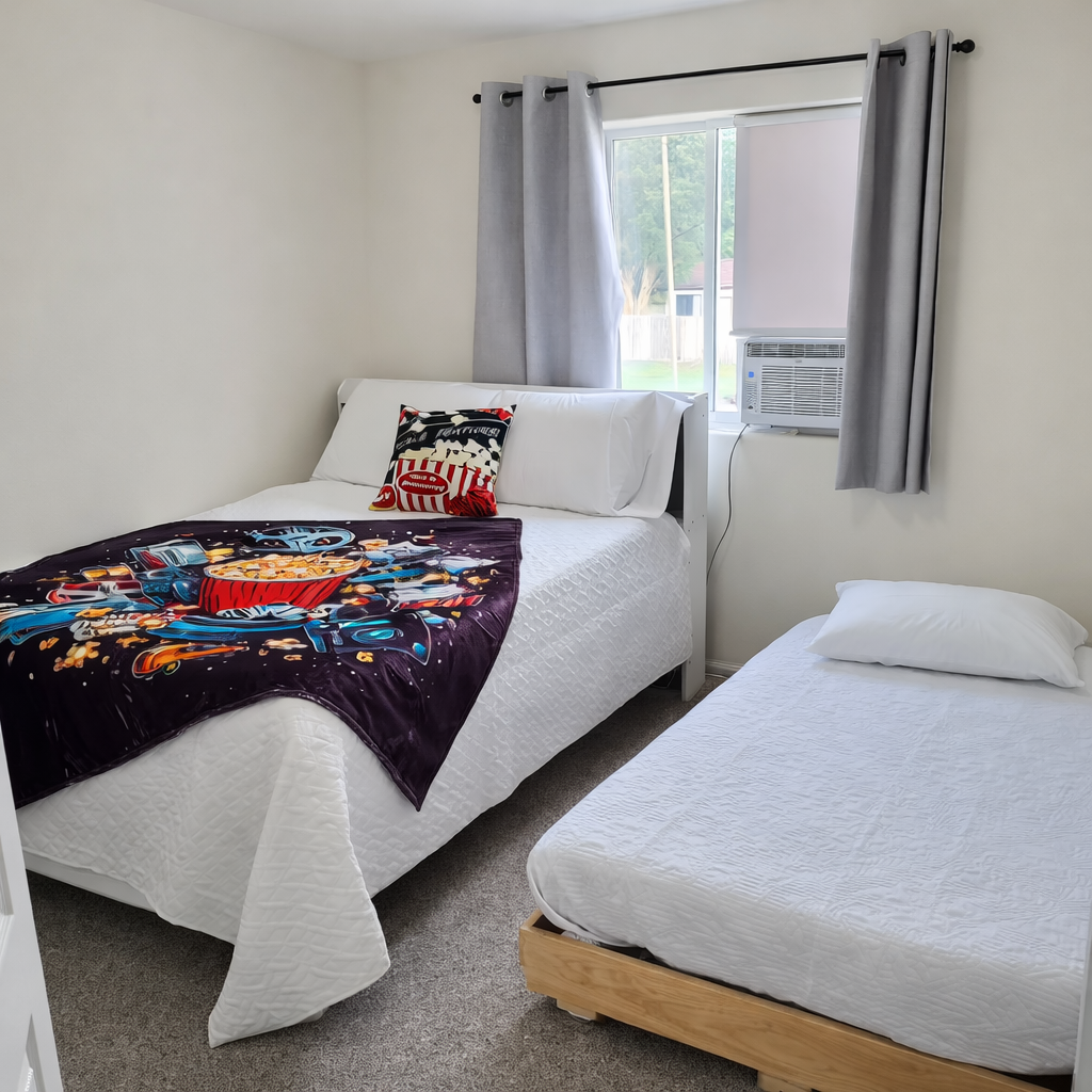 Versatile guest bedroom in Fountain, CO featuring a full-sized bed and a pull-out twin trundle, providing two individual sleeping spots for large families or sports team rosters.
