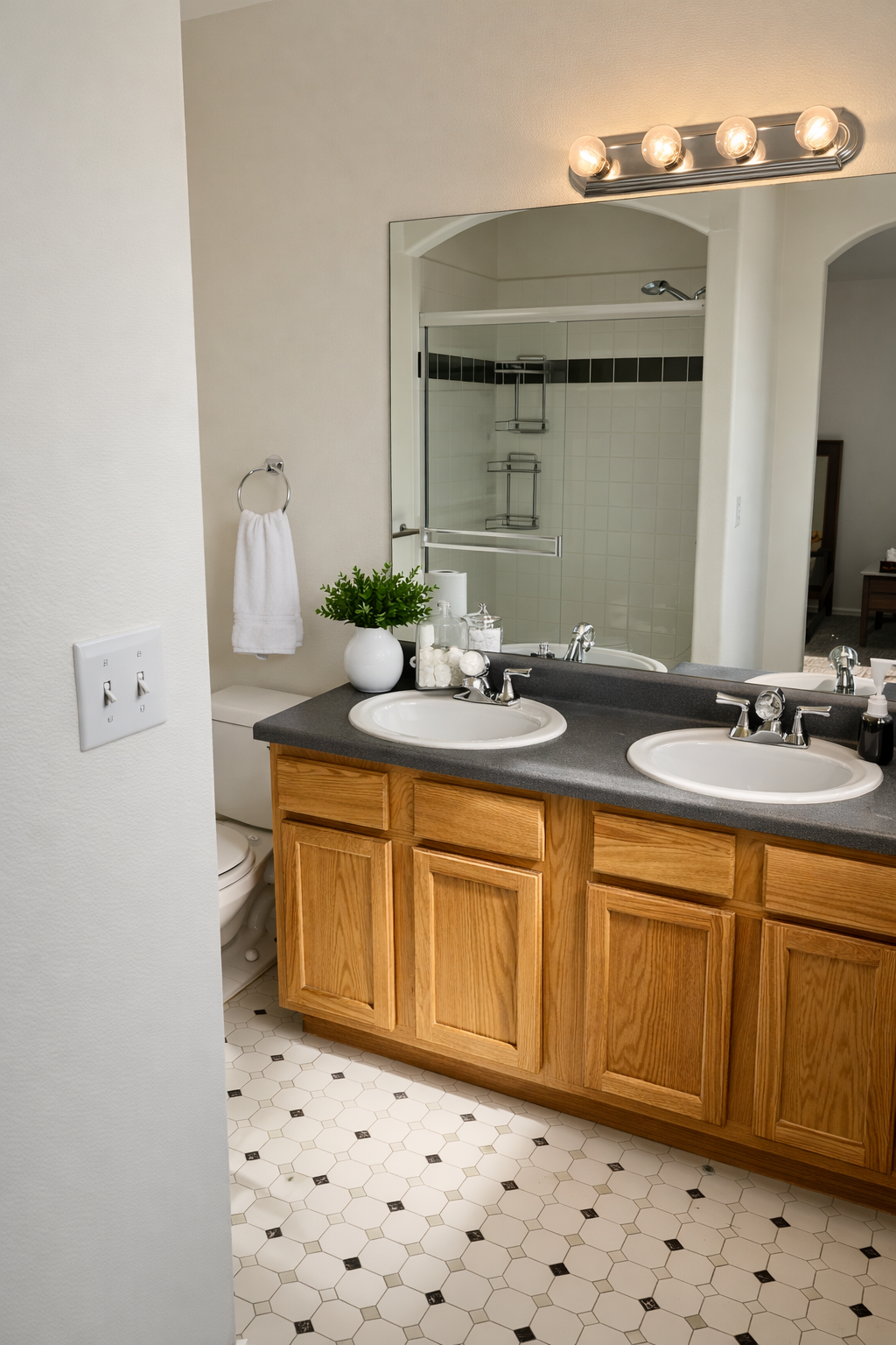 Master bathroom with double vanity and dual sinks in our Fountain, CO vacation home, offering high-capacity grooming space for sports teams competing at Sky View or families during a Fort Carson PCS move.