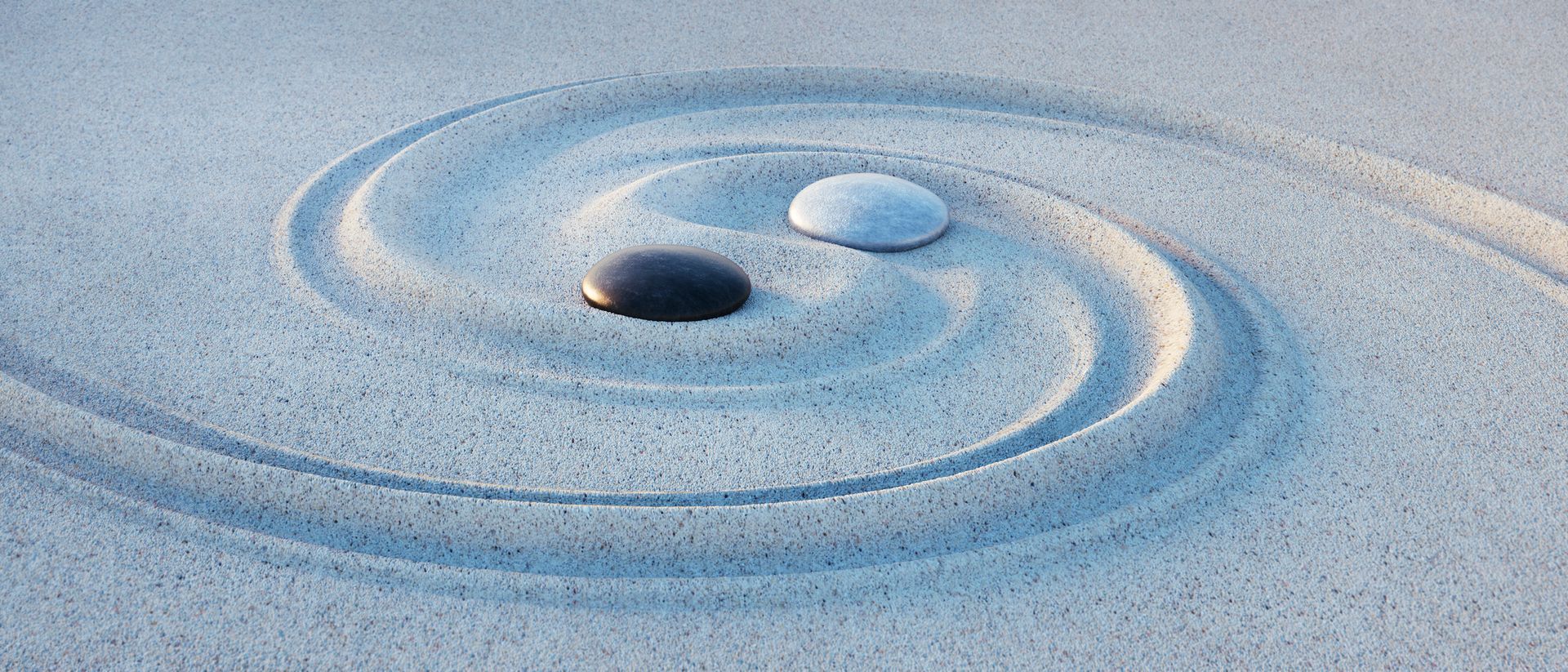 Yin-Yang symbol with stones and sand