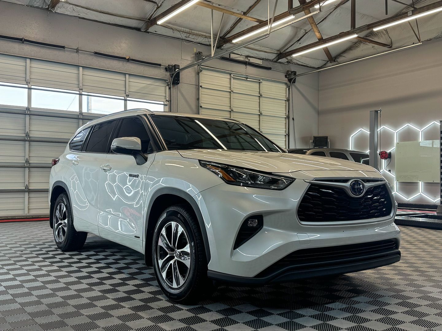 A white audi a5 is covered in plastic wrap.