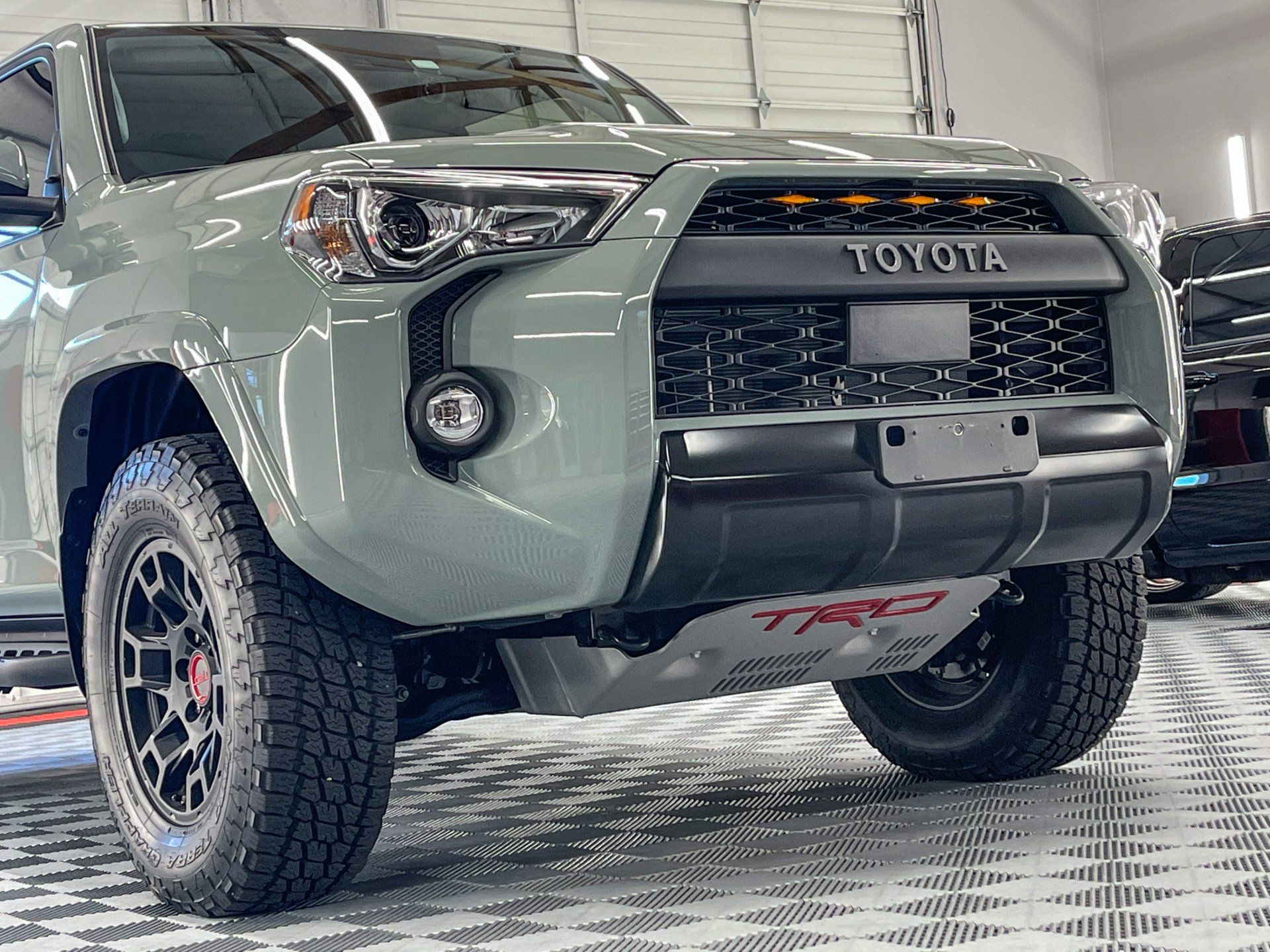 A white audi a5 is covered in plastic wrap.