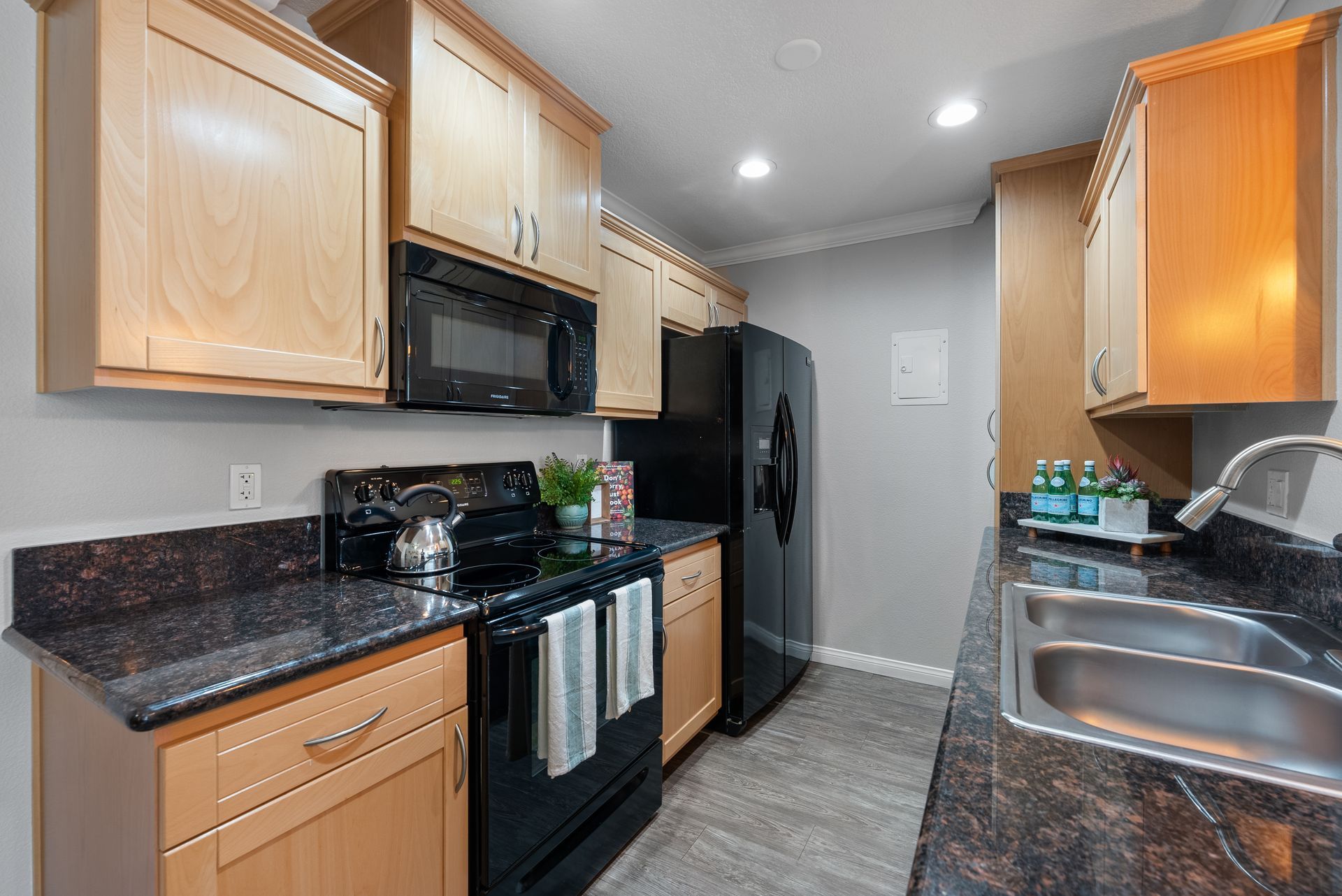 Kitchen with fridge, sink, microwave, and stove