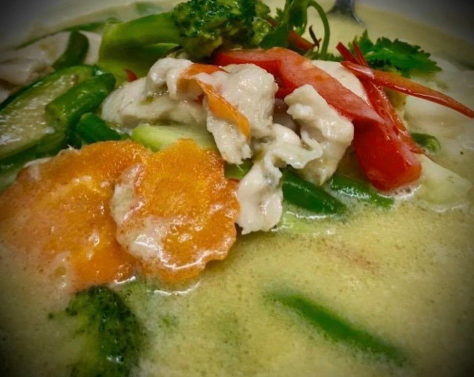 A close up of a bowl of soup with meat and vegetables