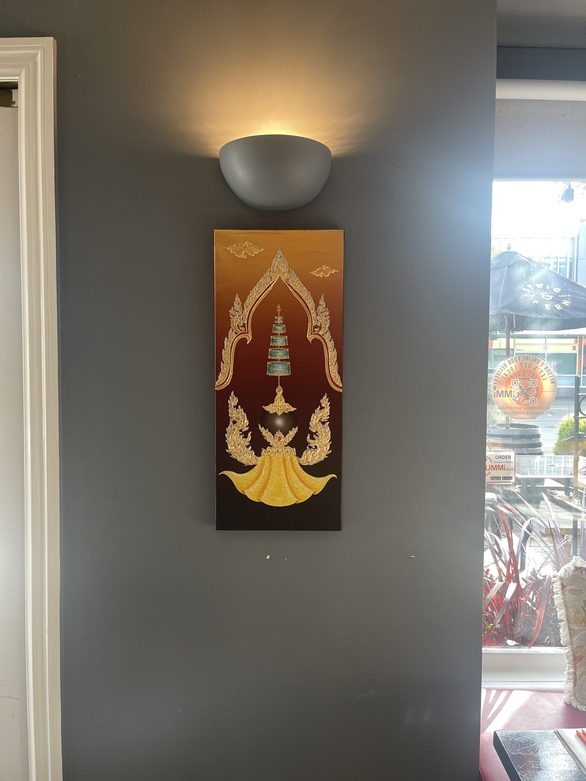 A painting is hanging on a wall next to a window