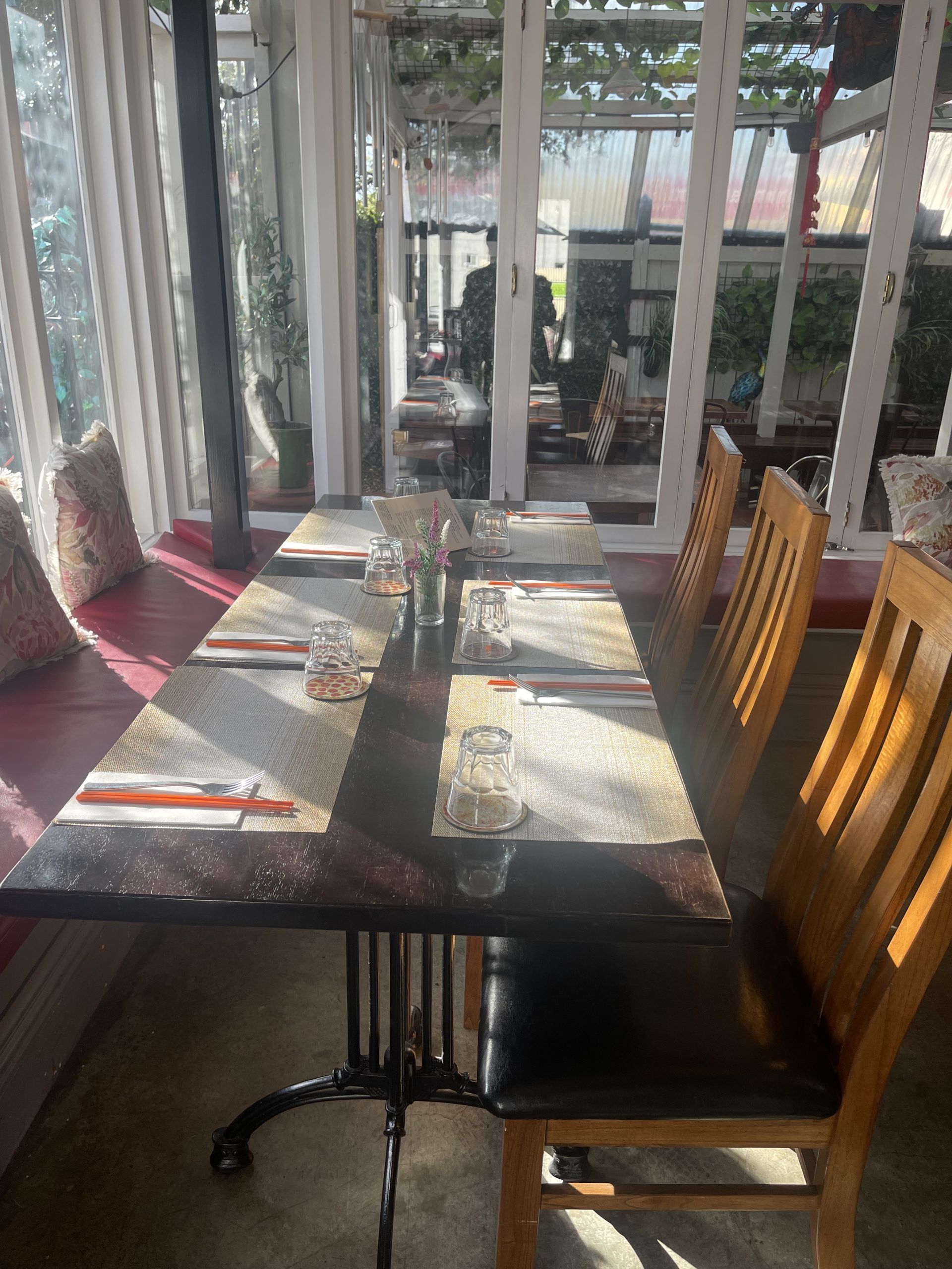 A restaurant with tables and chairs set up for a meal