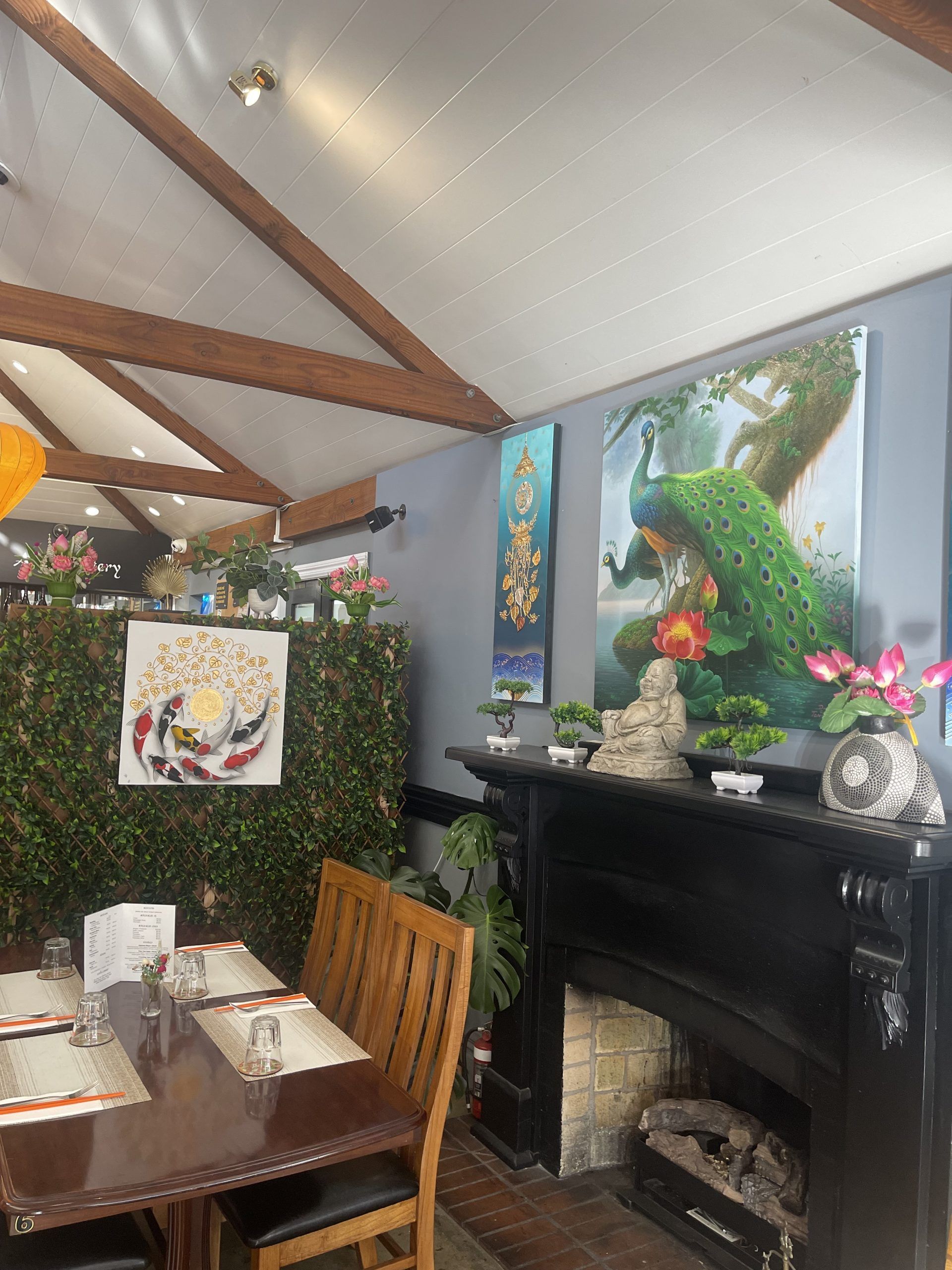 A restaurant with tables and chairs and a fireplace