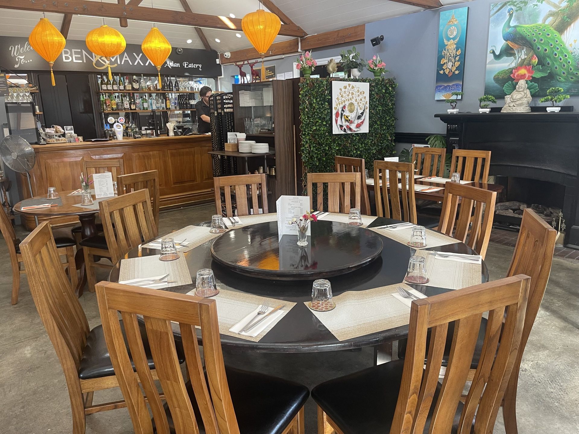A restaurant with tables and chairs set up for a meal.