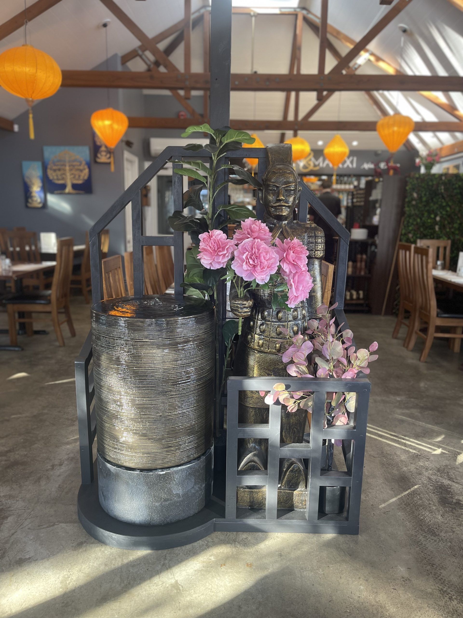 A restaurant with a staircase and a display of flowers
