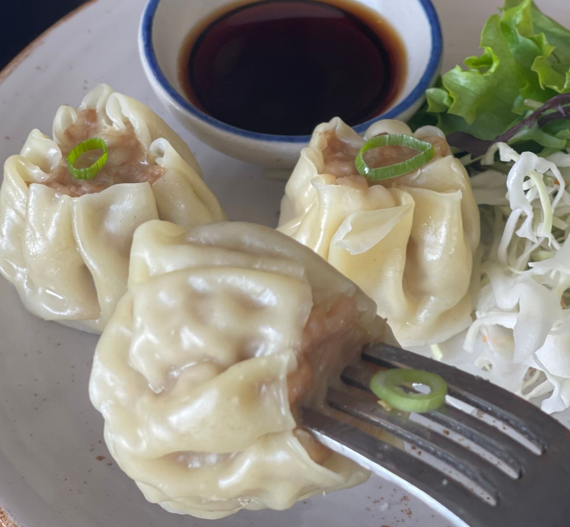 A close up of a plate of food with a fork in it