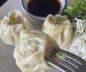 A close up of a plate of food with a fork in it.