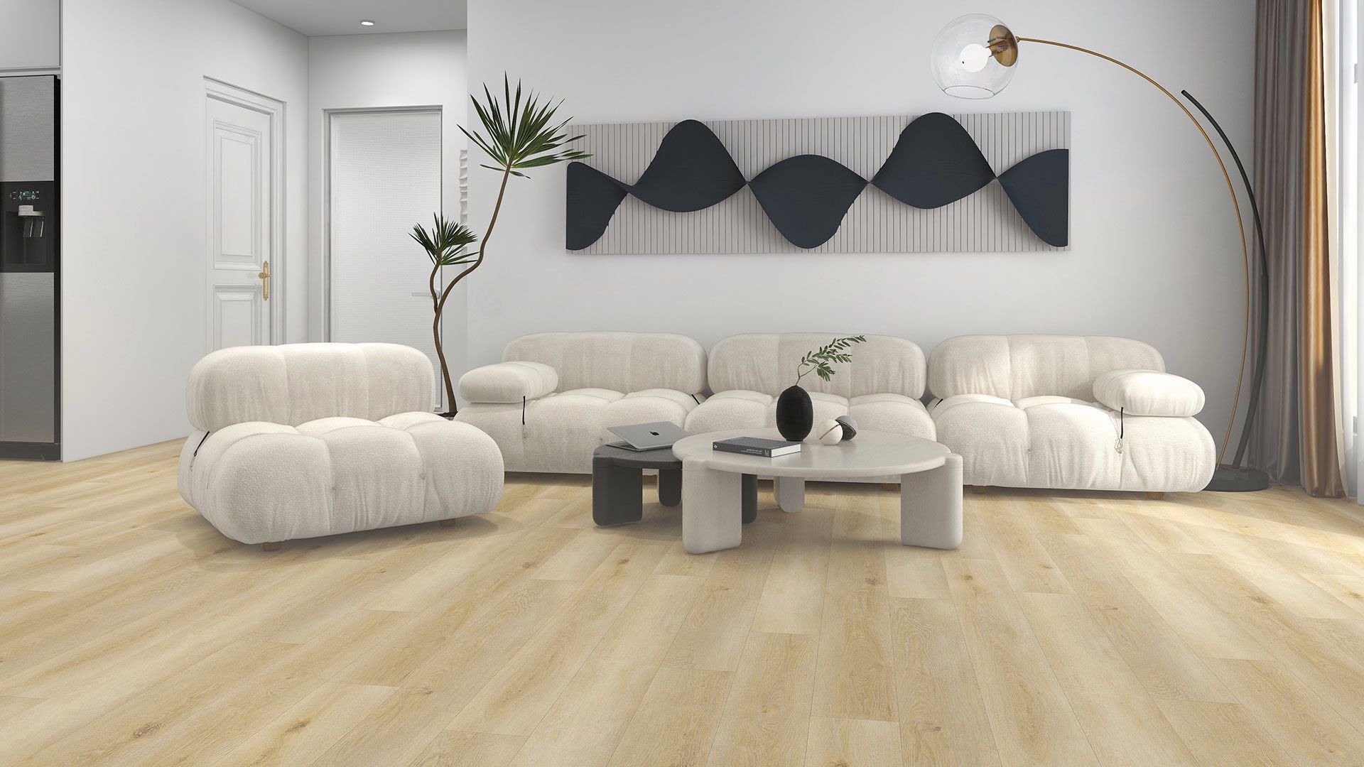 Living room with beige couch, light wood floor, white walls, and decorative art.