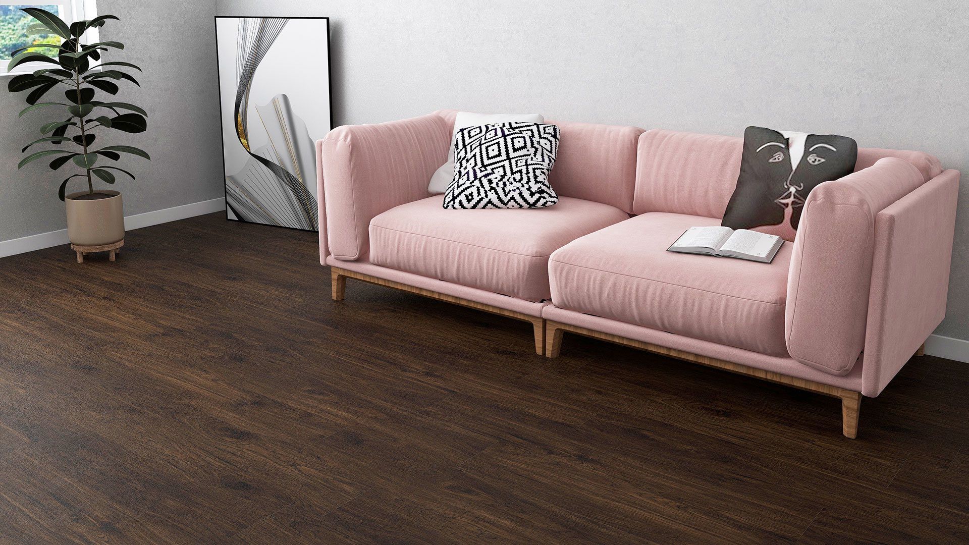 Pink sofa with pillows in a bright room, dark wood floor, plant and abstract art in the background.