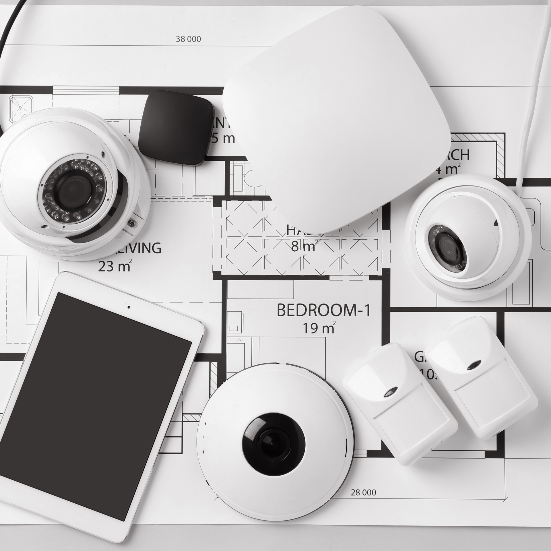 A bunch of security cameras are sitting on top of a floor plan.