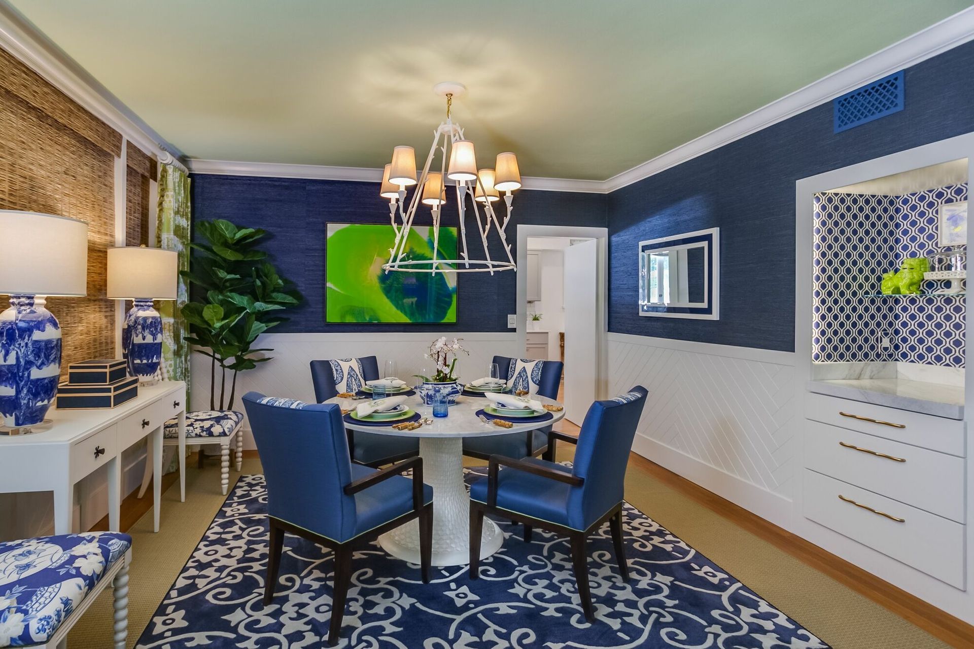 A dining room with a round table and blue chairs