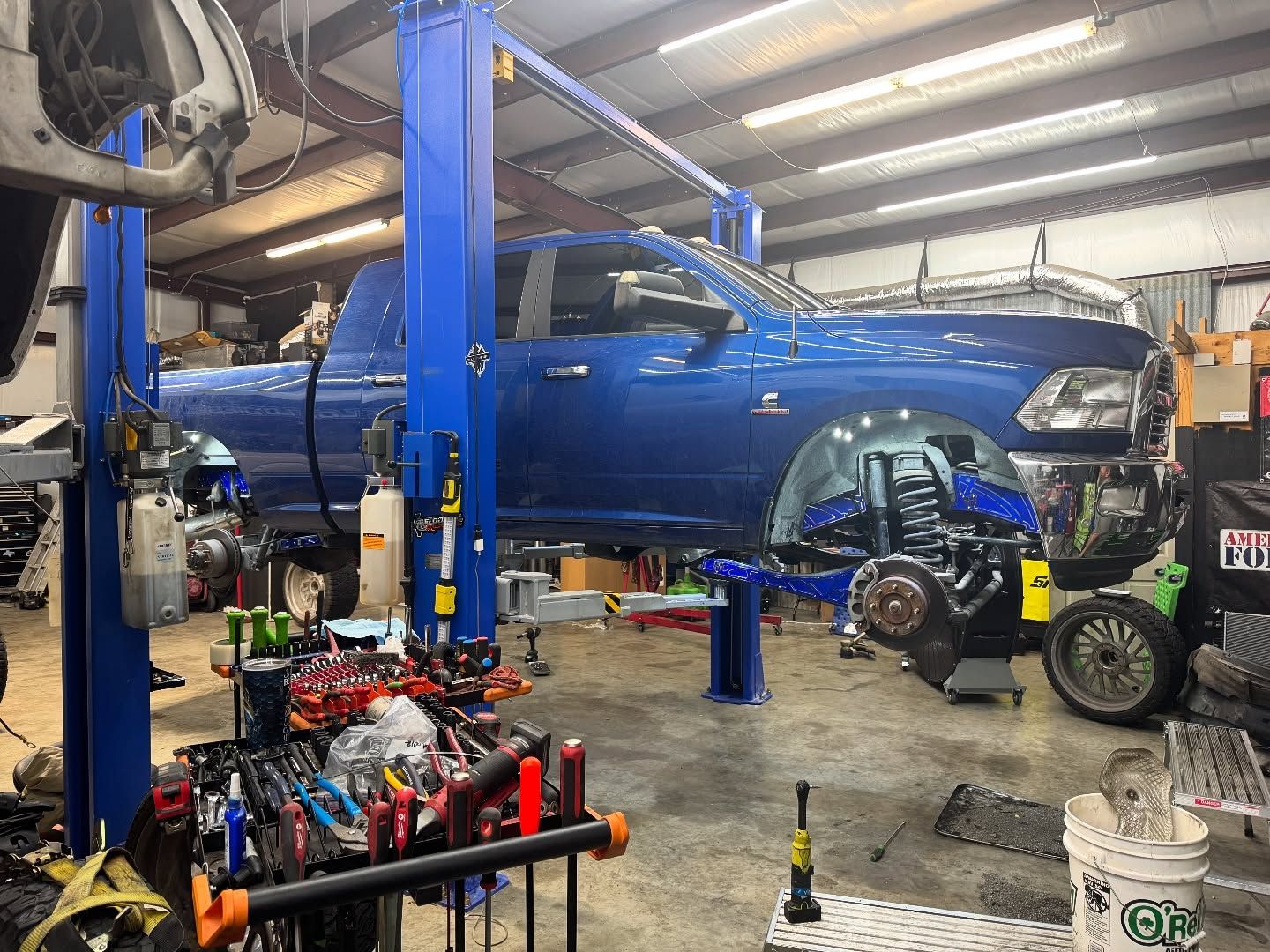 Blue Pickup Truck Raised on a Lift | Flo Diesel Performance